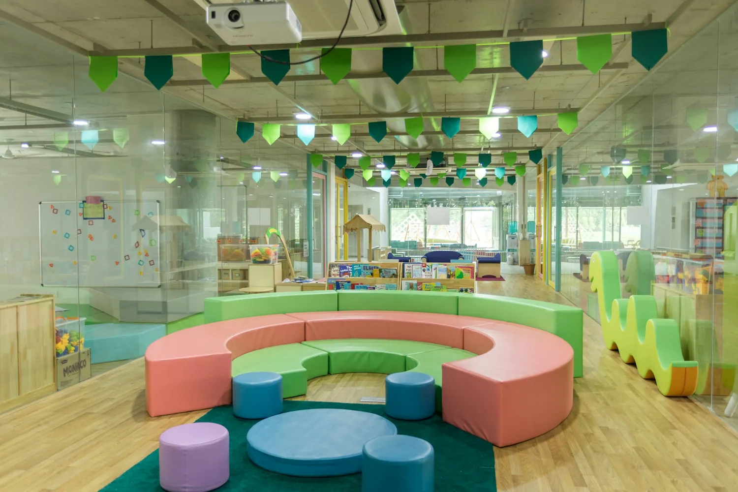 A bright classroom reading corner with pastel seating